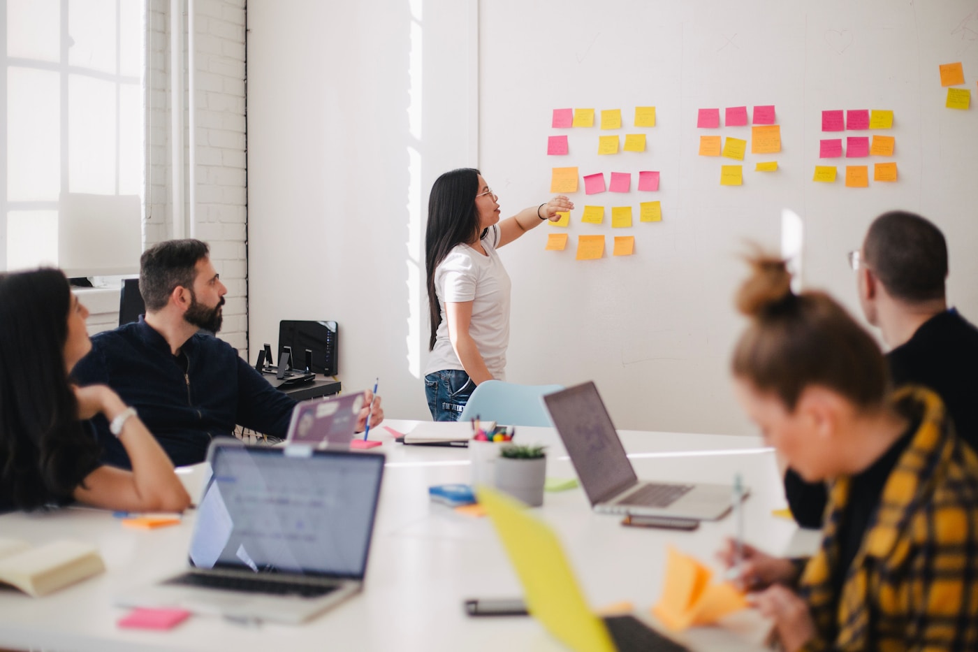 Instructor mapping AI workflow modules on a whiteboard